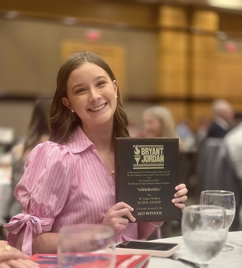  Photo of Jada Mock holding plaque